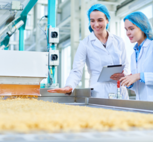 2 factory women workers looking at food line